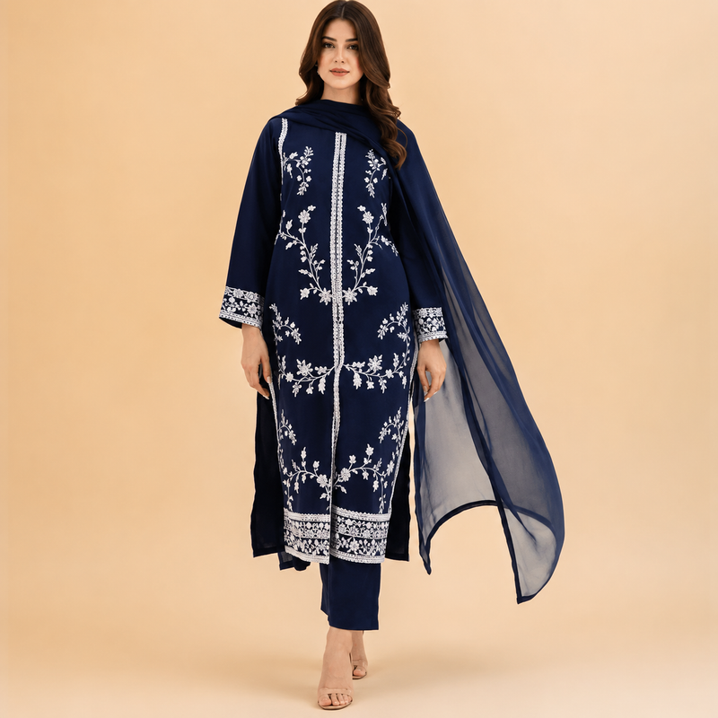 Woman wearing a navy blue embroidered dress with a sheer dupatta on a beige background