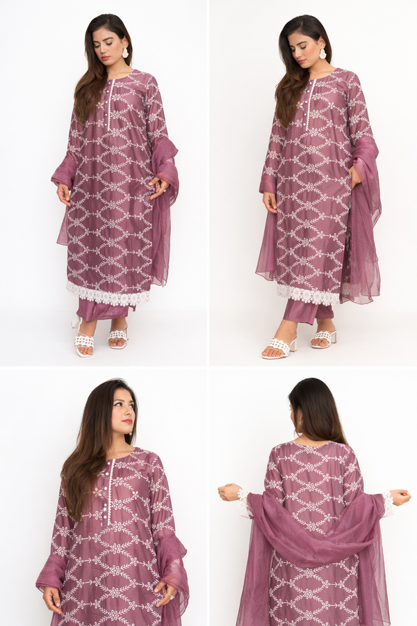 Woman modeling a purple patterned outfit with a white background