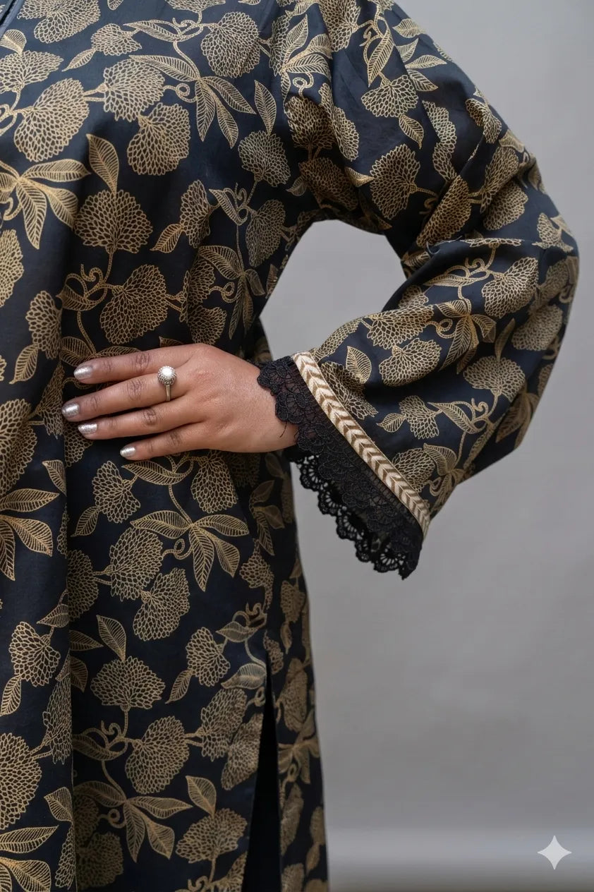 Dark fabric with gold floral pattern and lace trim on a plain background
