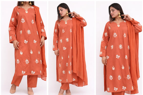 Woman wearing an orange floral outfit with a white background