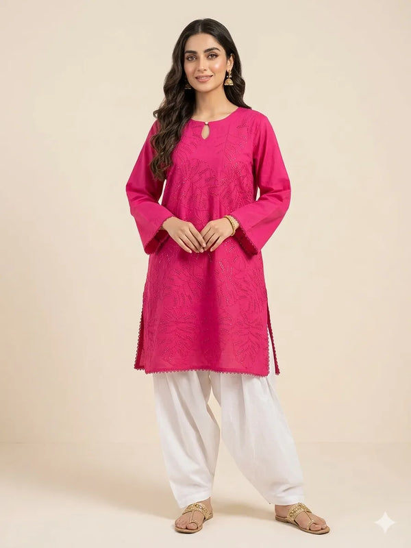 Woman wearing a bright pink kurta with white pants on a beige background
