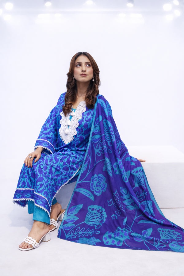 Woman wearing a blue floral traditional outfit on a white background