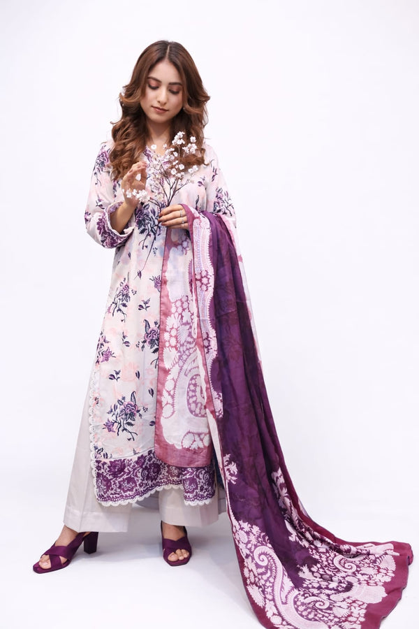 Woman wearing a floral dress with a purple dupatta on a white background