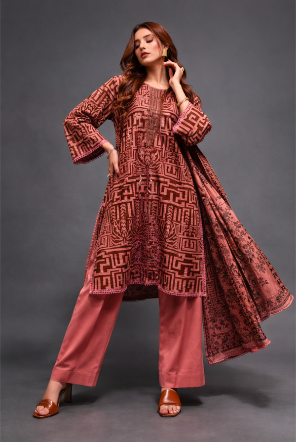 Woman wearing a patterned outfit on a gray background