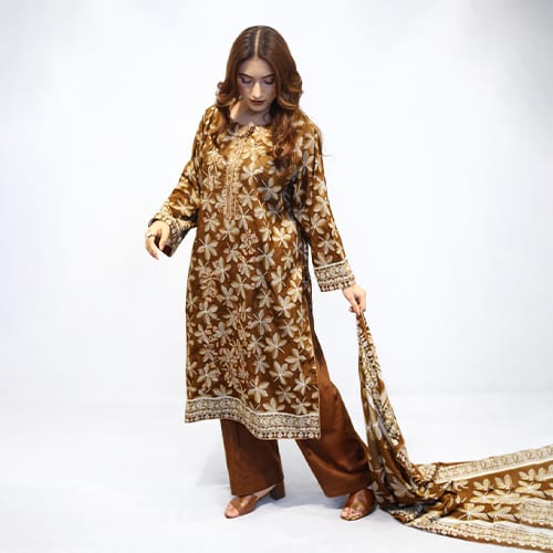 Woman wearing a brown floral embroidered outfit with a matching dupatta on a white background