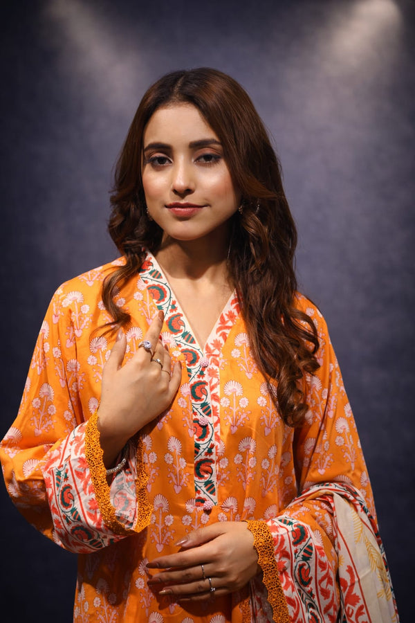 Woman wearing an orange and white patterned kurta against a dark background