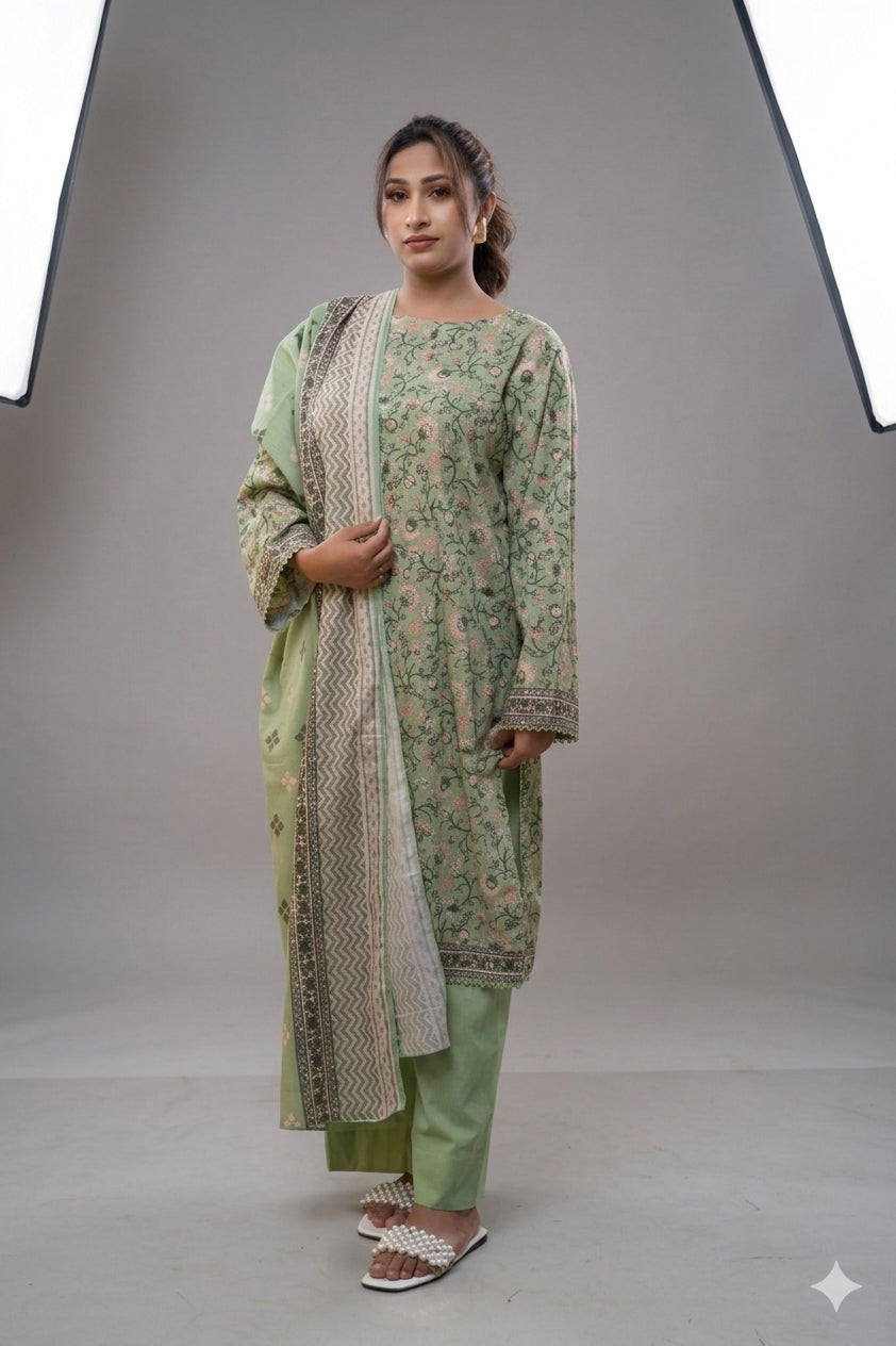 Woman wearing a green traditional outfit with a white dupatta against a gray background