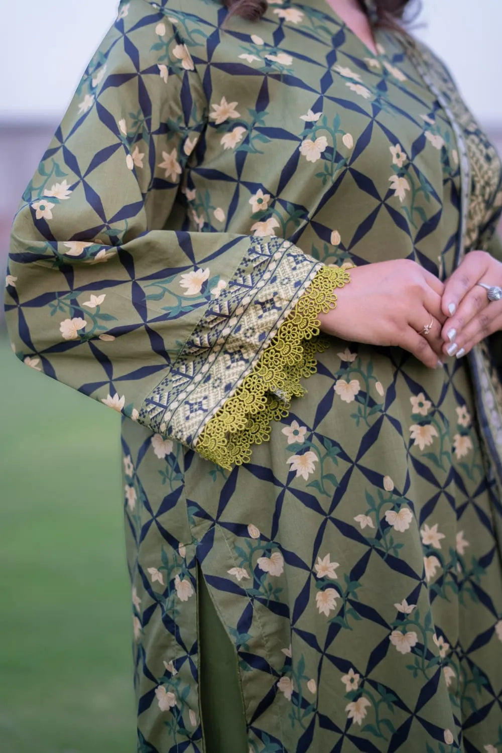 Green patterned garment with floral design and textured fabric