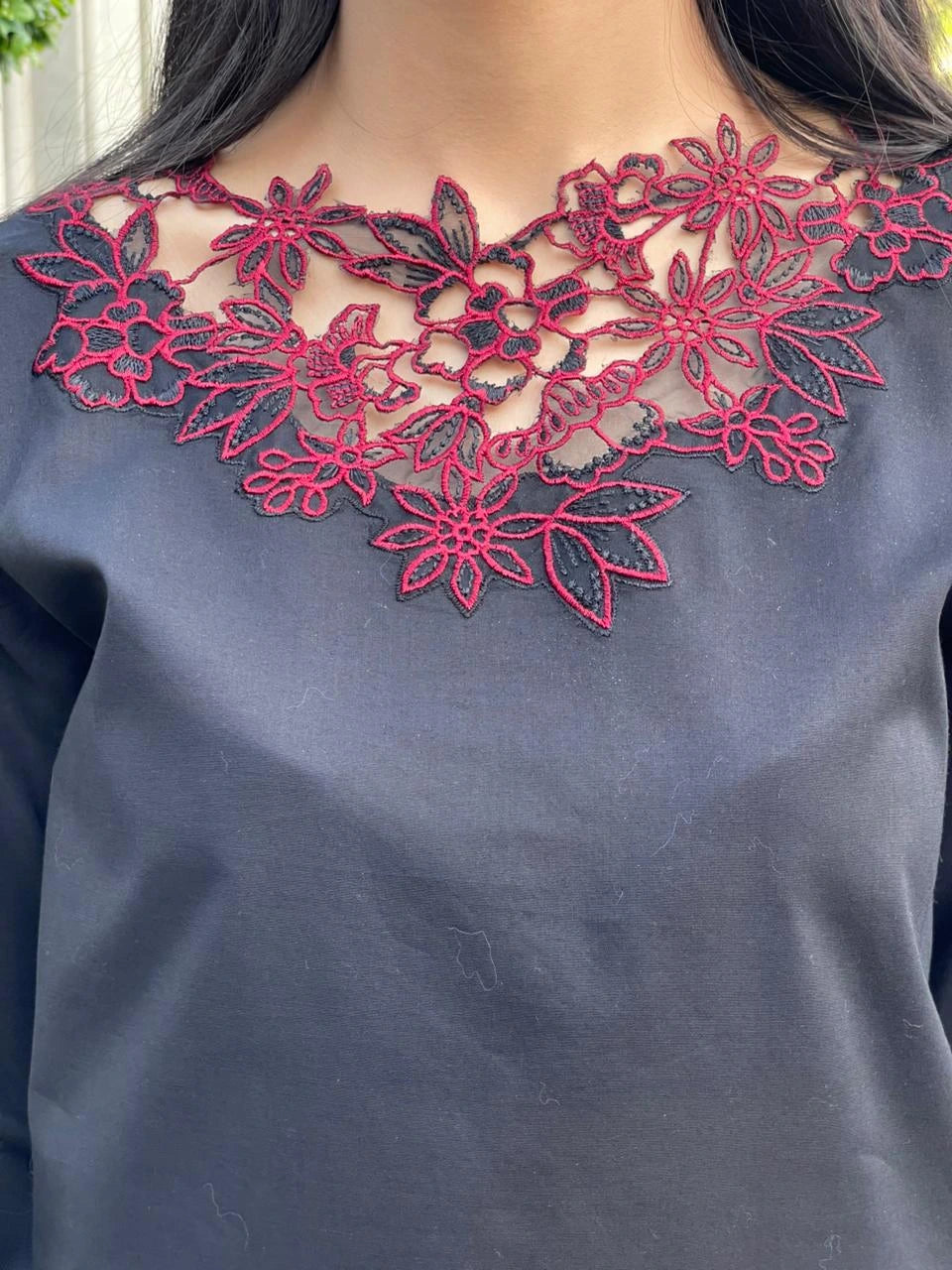 Navy blue top with red floral lace neckline